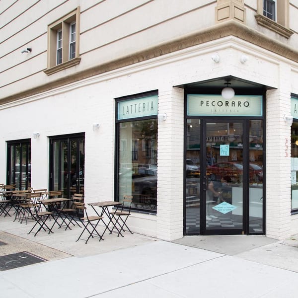 Exterior of Pecoraro Latteria, an Italian restaurant, with outdoor seating on the sidewalk.